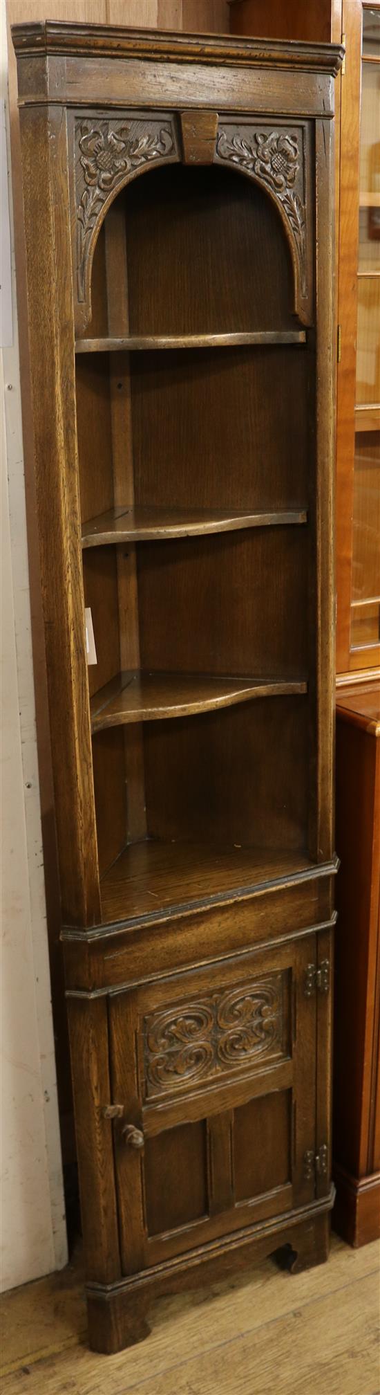 A narrow carved oak standing corner cupboard W.45cm